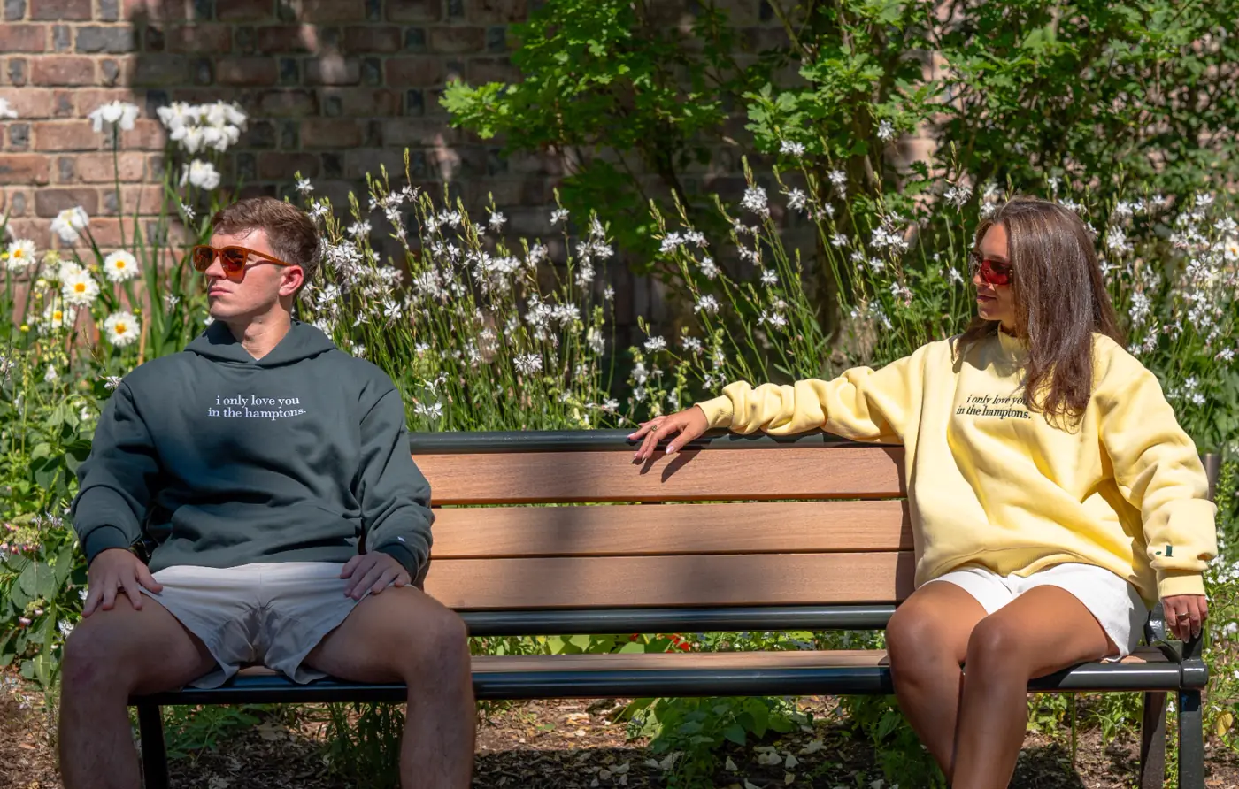 Two on a bench, both looking away