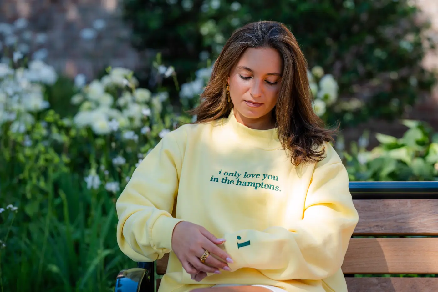 Yellow crewneck detail — sleeve embroidery